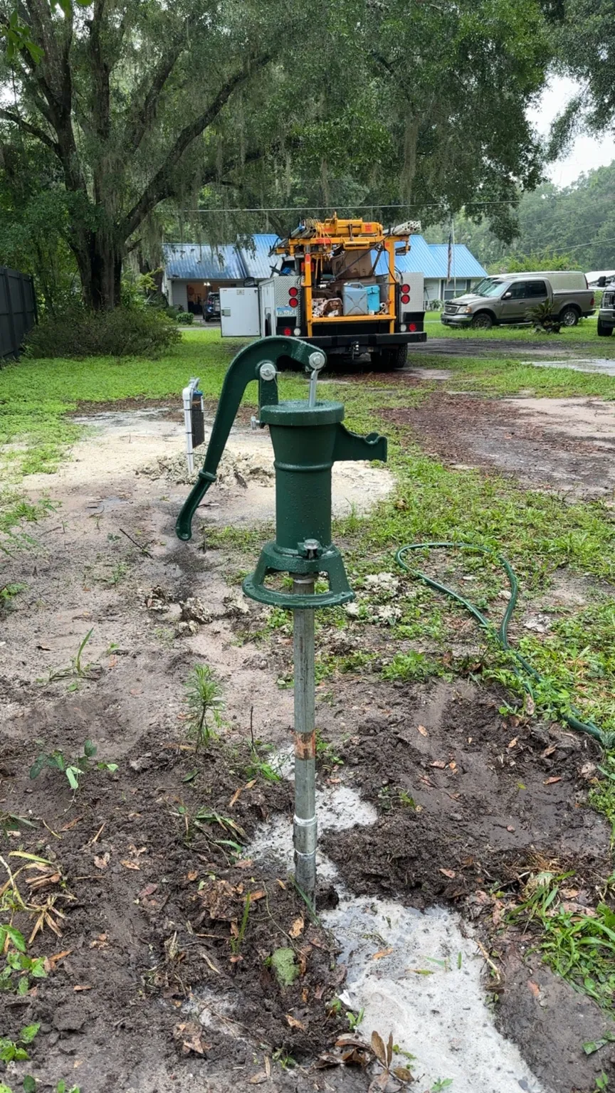 Installed traditional green cast-iron hand pump