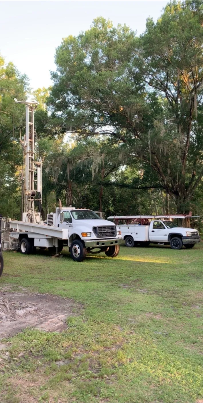 AL’s large drilling rig and service truck