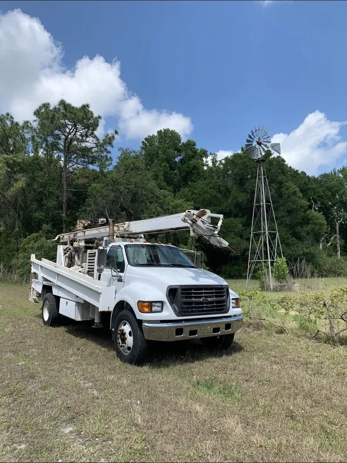 AL’s drilling truck beside a Florida windmill