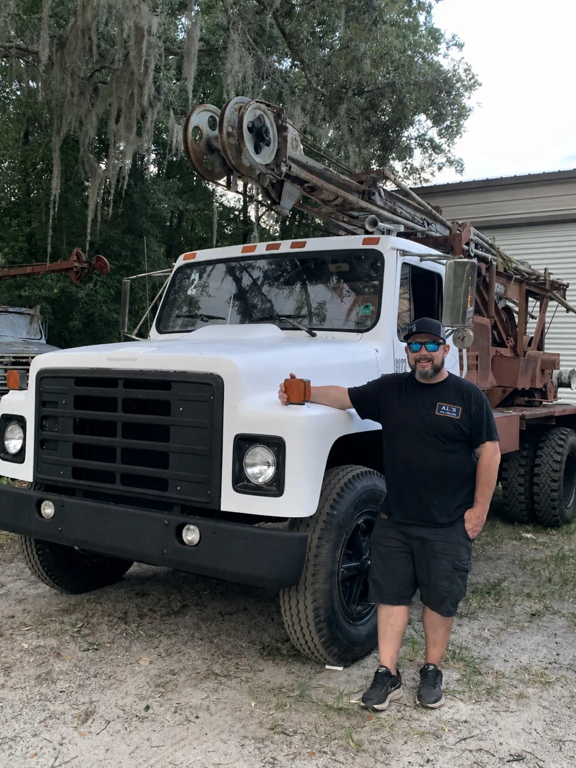 AL’s technician standing beside a well-drilling rig