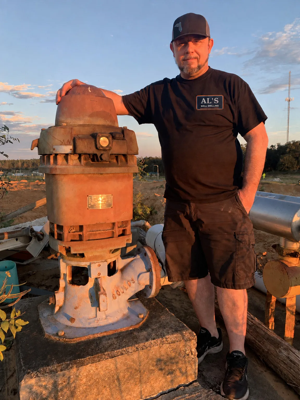 AL’s technician beside a large above-ground water pump