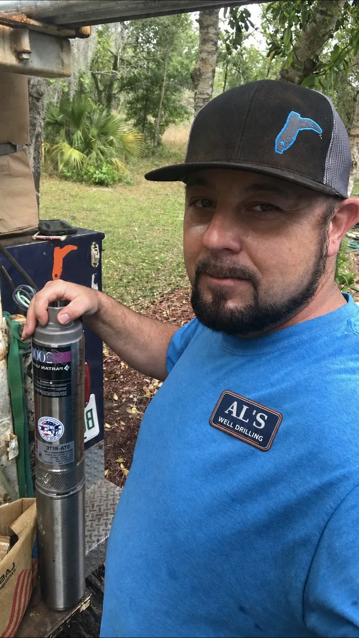 AL’s technician holding a submersible water-well pump
