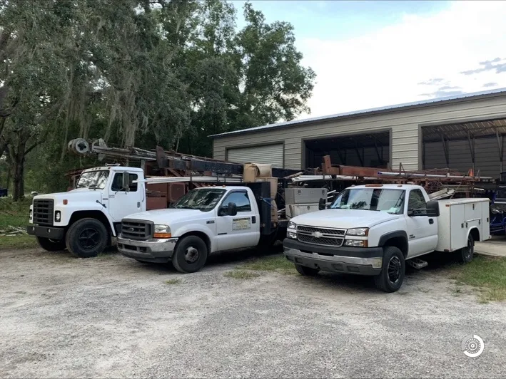 AL’s drill rig and service trucks at the shop